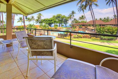 a balcony with chairs and a view of the water at Maui Kaanapali Villas E290 in Lahaina