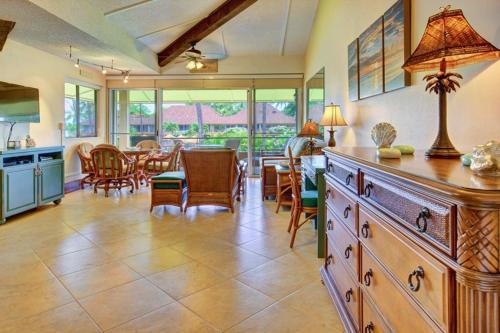 a kitchen and dining room with a table and chairs at Maui Kaanapali Villas E290 in Lahaina