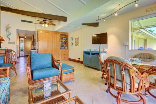 a living room with a table and chairs at Maui Kaanapali Villas E290 in Lahaina