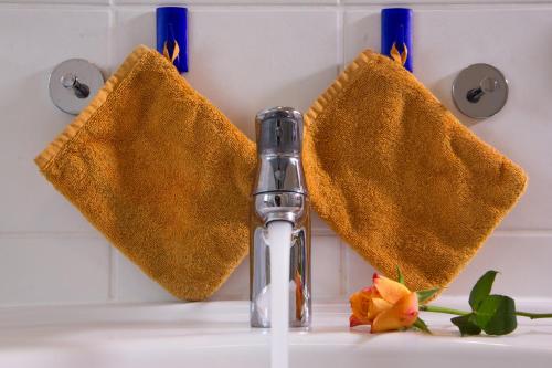 a bathroom sink with two towels next to a faucet at Ferienwohnung Am Sonnenhang in Neualbenreuth