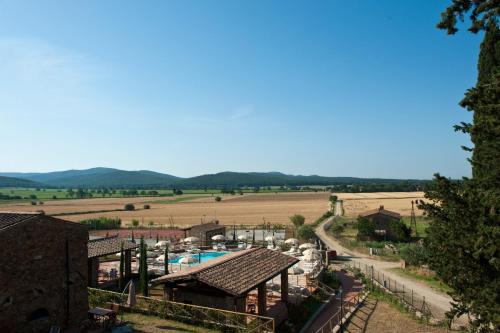 a view of a resort with a pool and a field at Antico Borgo Casalappi in Campiglia Marittima
