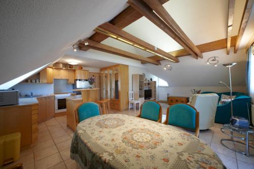 a kitchen and living room with a table and chairs at Vila Ana Generoes Bled in Bled