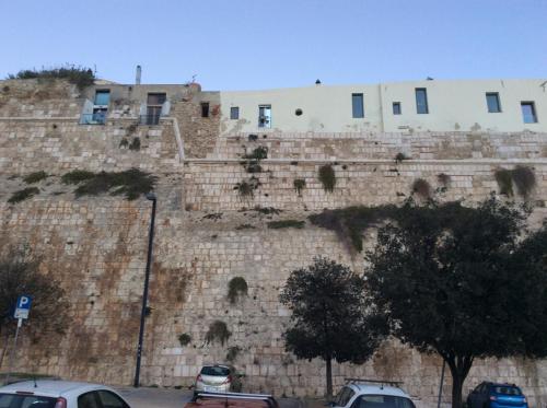 a building on the side of a stone wall at Old castle S. Croce in Cagliari