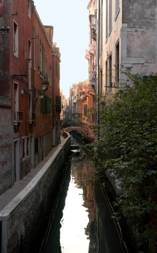 a canal in a city with buildings and water at Hotel Al Ponte Mocenigo in Venice