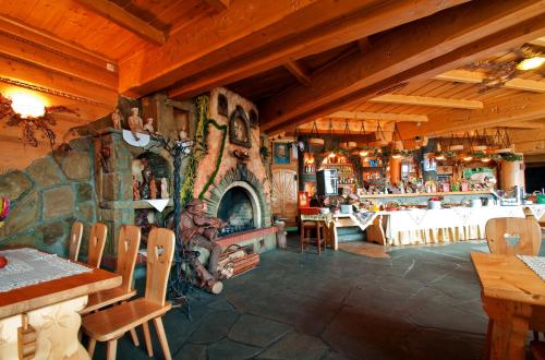 a large room with a stone fireplace in a restaurant at Skalny Dworek in Nowy Targ