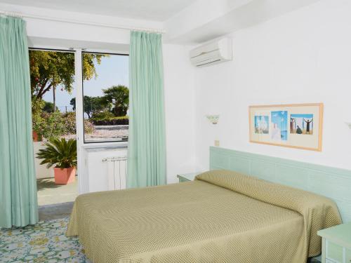 Postel nebo postele na pokoji v ubytování Hotel Parco Cartaromana