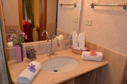 a bathroom counter with a sink and a mirror at Grand Hotel Montesilvano in Montesilvano