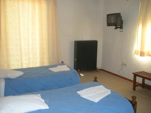 Un ou plusieurs lits dans un hébergement de l'établissement Villa Kalavrita Hotel