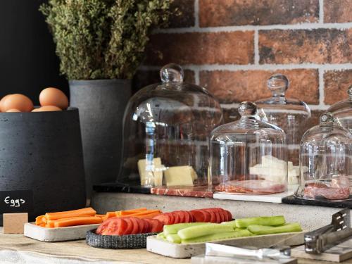 a counter with some vegetables andason jars and eggs at 18 Micon Str. in Athens