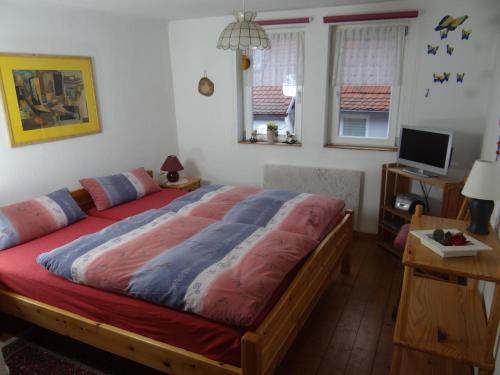 a bedroom with a large bed in a room at Ferienhaus Heimberger in Miltenberg