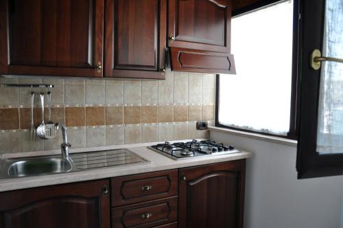 a kitchen with a stove and a sink and a window at Al Borgo Antico Ristorante e B&B in Crispiano
