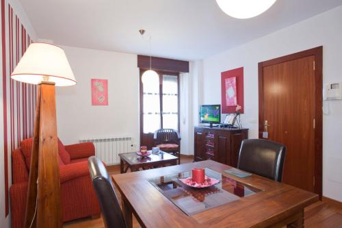 a living room with a dining room table and a couch at La Fonda de Bustio in Bustio