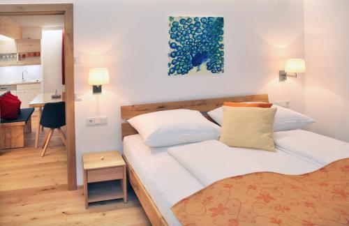 a small bedroom with a bed and a kitchen at Stockklauser in Lofer