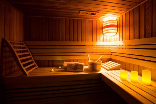 a sauna with a ladder and a chair in it at Apartamenty Bystra in Bystra