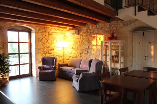 a living room with a couch and chairs and a table at Tenuta Zannafondo in Donnafugata