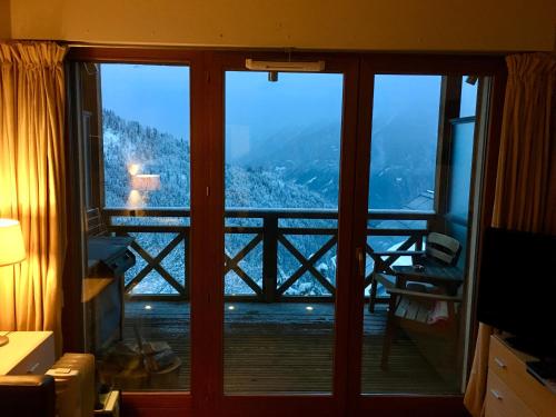 a room with a view of a balcony at Les Ecureuils Squirrel Lodge in Oz
