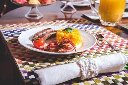 a plate of breakfast food on a table at Callegherie 21 Boutique B&B in Imola