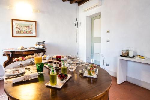 a table with plates of food and drinks on it at Callegherie 21 Boutique B&B in Imola