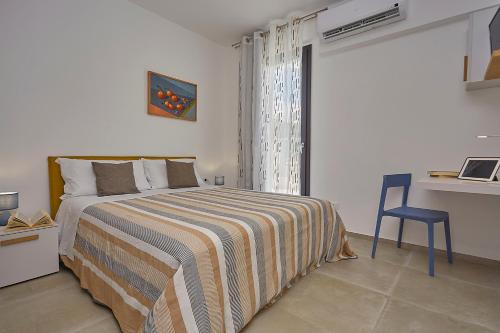 a bedroom with a bed and a desk and a table at Villa Vo' Scurá in Alcamo Marina