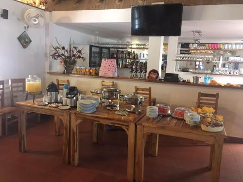 a wooden table with dishes on it in a restaurant at Awa De Mar Hotel Tolu in Tolú