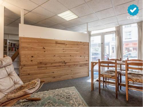 a room with a wooden wall with a bed and a chair at Friendly Budget-Studio 35m2 Paris Montmartre in Paris