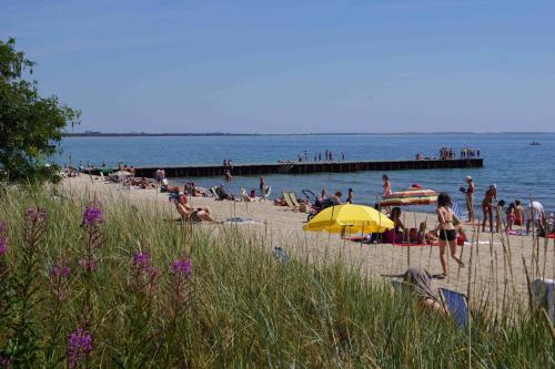 a group of people on a beach near the water at Ystad Camping in Ystad