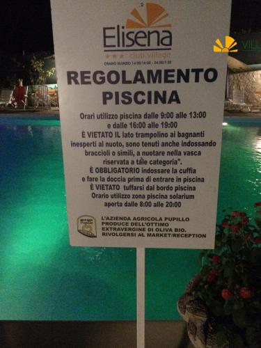 a sign that is next to a swimming pool at Villaggio Elisena in Vieste