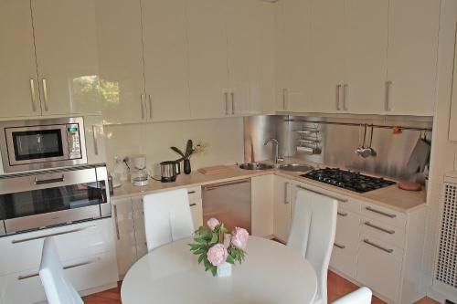 a kitchen with a table with a vase of flowers on it at Lake View 9 in Como