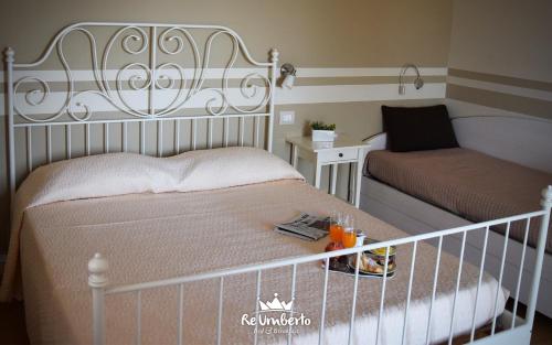 a small bedroom with a bed and a crib at RE UMBERTO b&b - Suite di charme e Country rooms in San Salvo