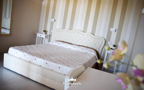 a bedroom with a white bed in a room at Re Umberto Suite in San Salvo