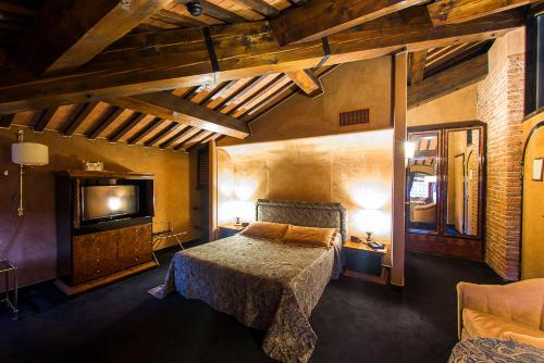 a bedroom with a bed and a flat screen tv at Relais Villabella Hotel in San Bonifacio