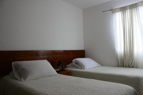 
Cama o camas de una habitación en Hostal Quepay
