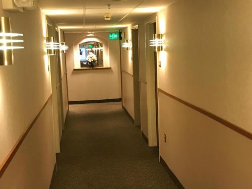 a long hallway with lights on the walls at Americas Best Value Inn Cedar City in Cedar City