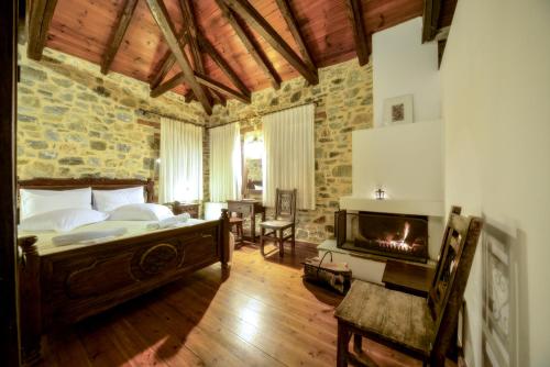 a bedroom with a bed and a fireplace at Eos - Authentic Experience in Skíti