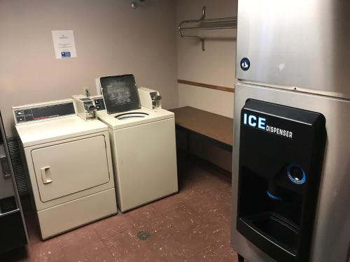 a laundry room with a washer and dryer and a refrigerator at Americas Best Value Inn Cedar City in Cedar City
