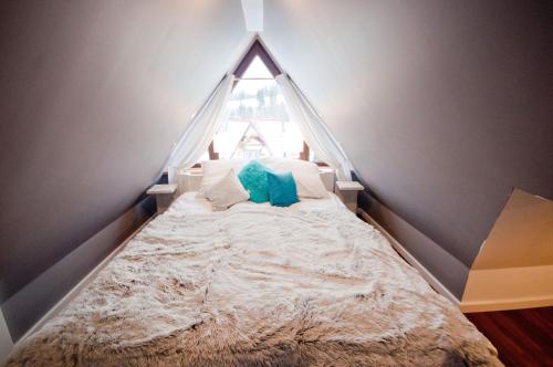 a bed in a room with a window at U Hanki in Biały Dunajec