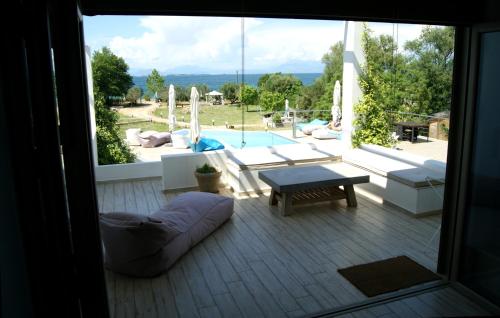 a view of a patio with a pool and a table at Manna Gea in Vonitsa