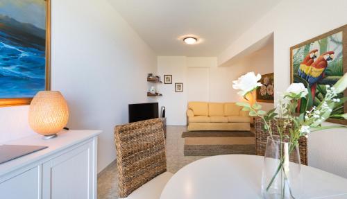a living room with a table and a couch at Villa Le Terrazze Charming Rooms in Taormina