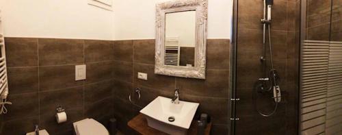 a bathroom with a toilet and a sink and a shower at Nenetta Rooms & Suites Monopoli in Monopoli