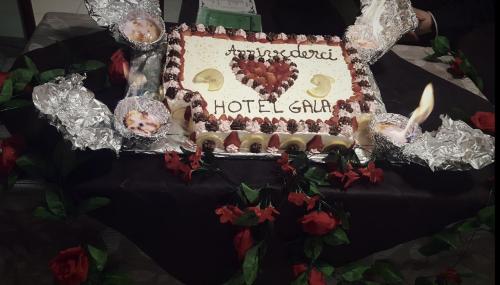 a birthday cake with a hotel sign on it at Hotel Gala in Pesaro