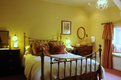 a bedroom with a bed and a chandelier at The Traddock in Austwick