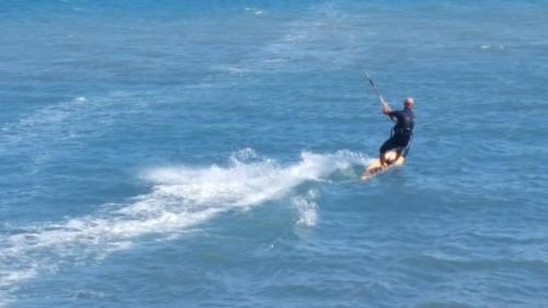 a man riding a wave on a board in the water at Agriturismo Fioredizucca in Albenga