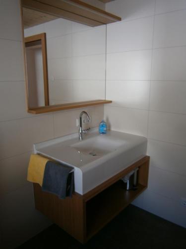 a white sink in a bathroom with a mirror at Haus Zitterklapfen in Au im Bregenzerwald