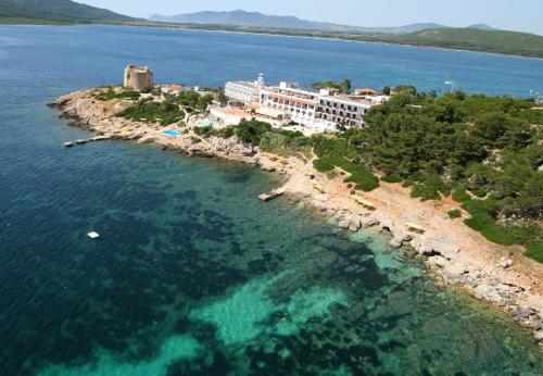 an aerial view of a resort on an island in the water at El Faro Hotel & Spa in Porto Conte