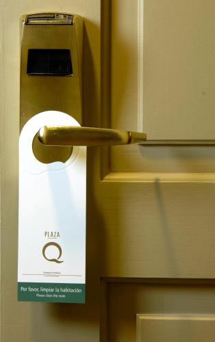 a doorhandle to a refrigerator with a sign on it at Austral Plaza Hotel in Comodoro Rivadavia
