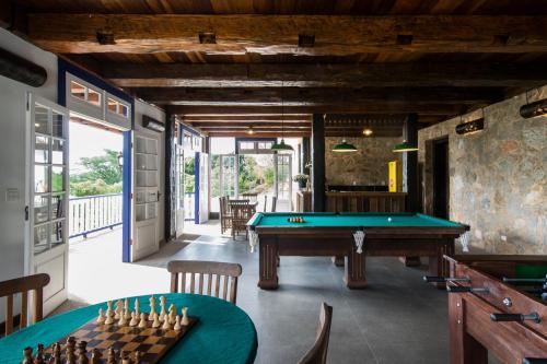 a billiard room with a pool table and a table sidx sidx sidx at Pousada Chão de Minas Ouro Preto in Ouro Preto