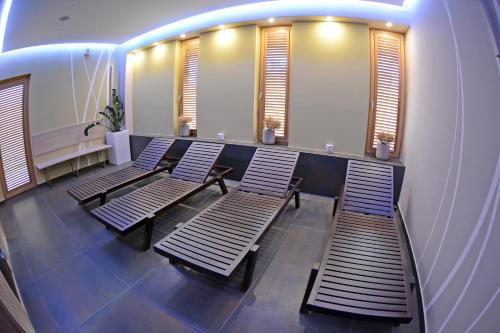 a row of benches in a room with windows at Hotel Gallus in Sesvete