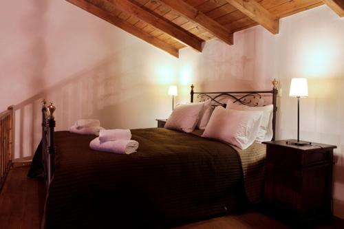 a bedroom with a bed with towels on it at Guesthouse Elaia in Synikia Mesi Trikalon