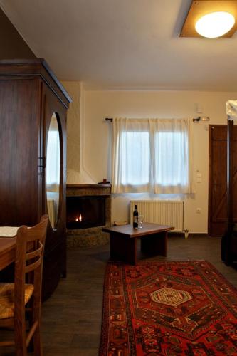 a living room with a table and a window at Guesthouse Elaia in Synikia Mesi Trikalon