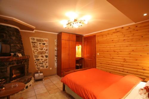 a bedroom with a bed and a fireplace at Exohiko in Palaios Agios Athanasios